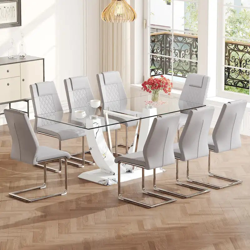 Ensemble de salle à manger moderne avec table en verre trempé, piètement en U à motif marbre et chaises rembourrées en similicuir.
